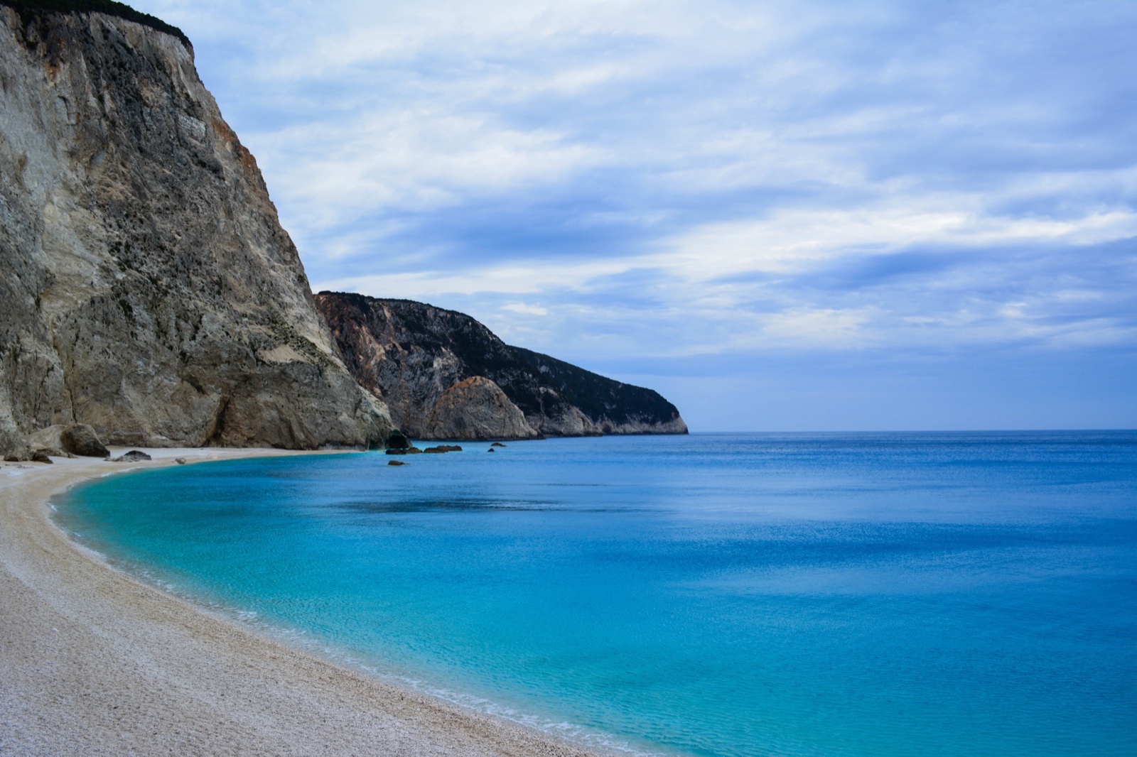 Sunlit towering limestone cliffs and radiant turquoise waters along Europe's premier coastline